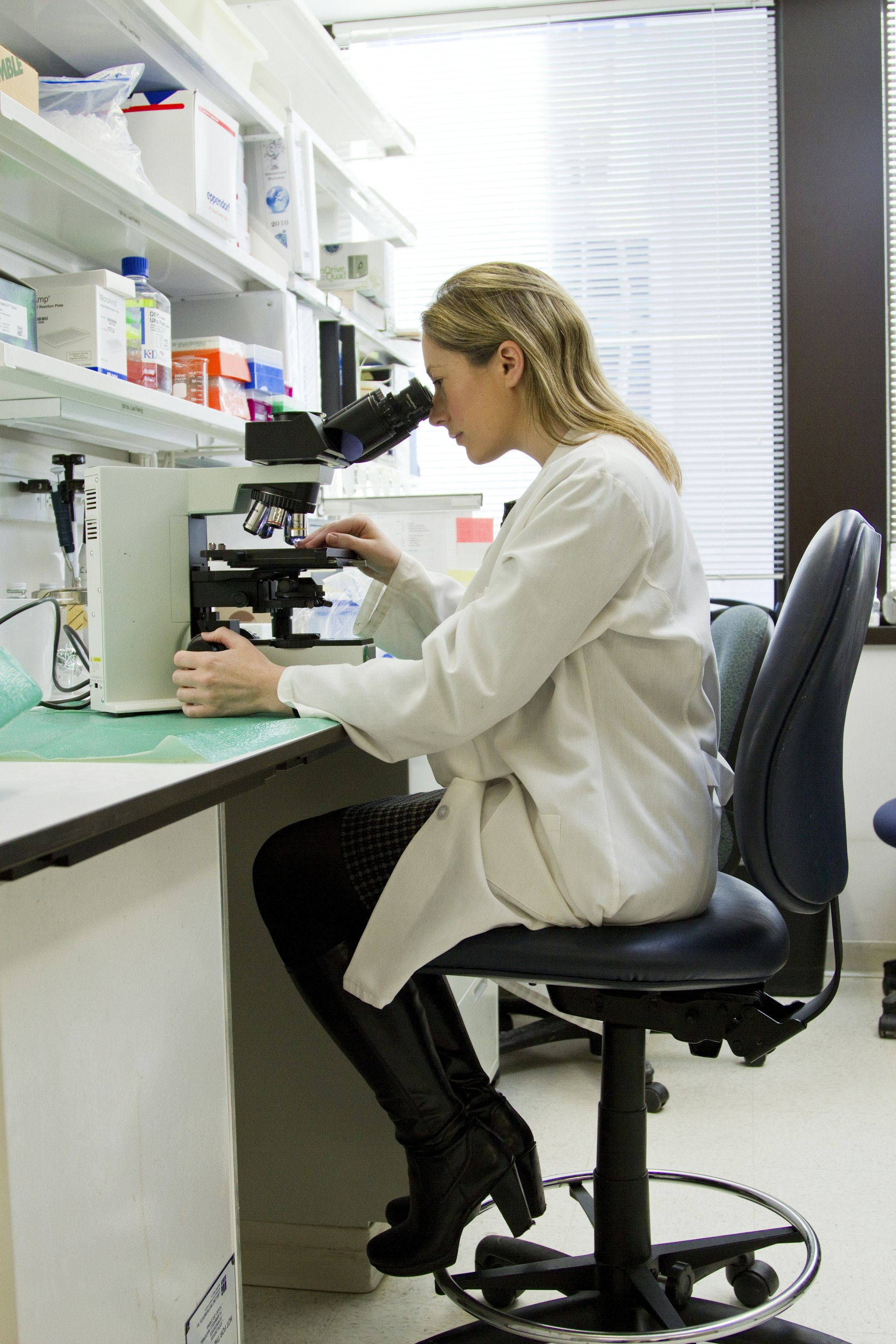 Pharmacist working at the compounding bench with a microscope